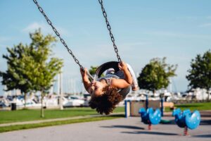 Small girl Childhood swinging at a playground in Marine Park in Blaine, Washington