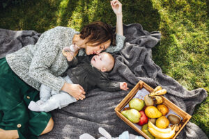 Mother with her little son having picnic on a back yard in Blaine's Park