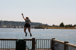 girl jumping in from the Jorgensen Pier