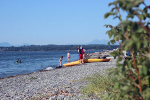 Kayakers prepare to paddle on the beach next to Semiahmoo Spit